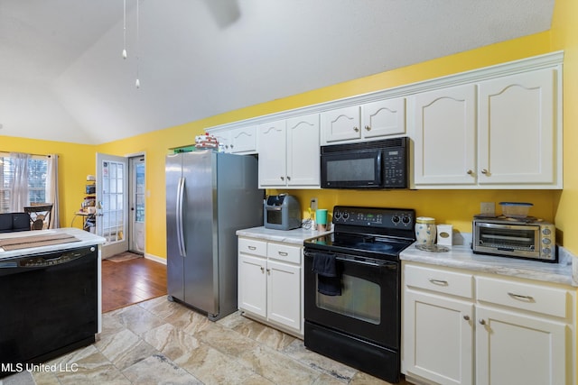 kitchen featuring black appliances, white cabinetry, lofted ceiling, and light wood-type flooring