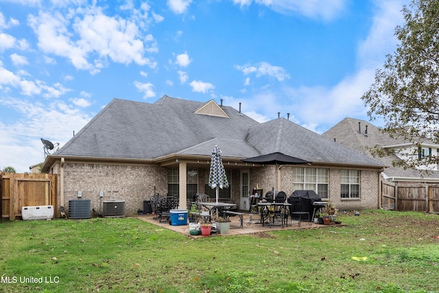 back of house with a patio, central AC, and a yard