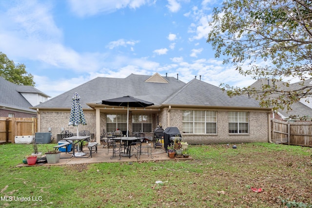 back of property featuring central air condition unit, a yard, and a patio area