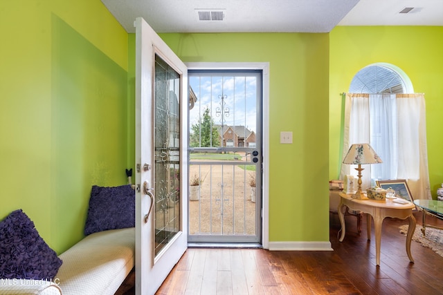 entryway with hardwood / wood-style flooring