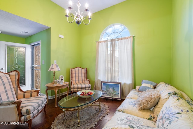 sitting room featuring hardwood / wood-style flooring and a chandelier