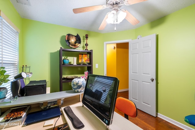 office space with a textured ceiling, hardwood / wood-style flooring, and ceiling fan