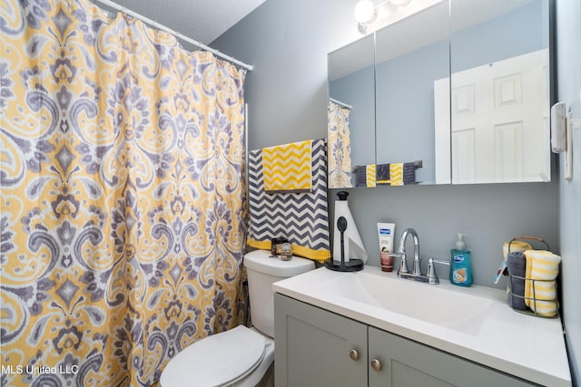 bathroom featuring vanity, a textured ceiling, toilet, and a shower with shower curtain