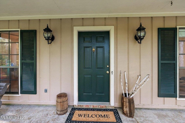 property entrance featuring a porch and board and batten siding