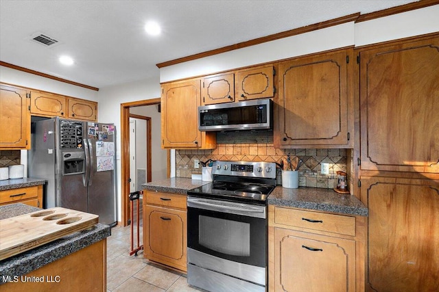 kitchen featuring appliances with stainless steel finishes, decorative backsplash, ornamental molding, and light tile patterned flooring