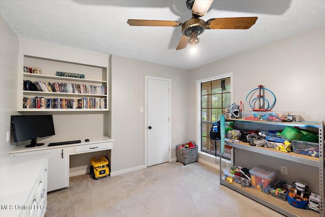 miscellaneous room with built in desk, a textured ceiling, and ceiling fan