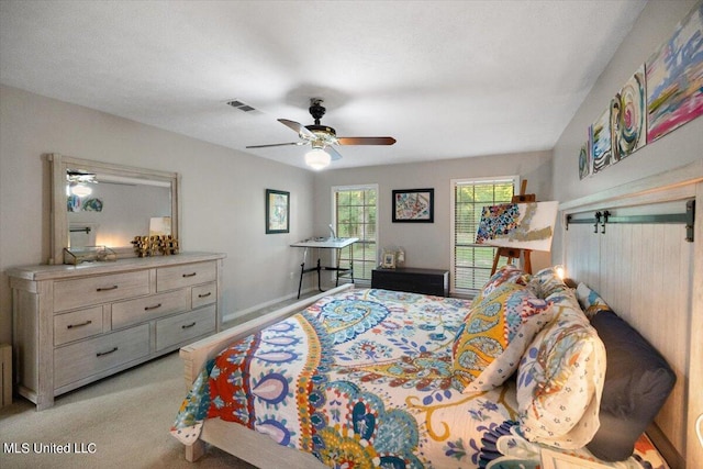 bedroom with light colored carpet and ceiling fan