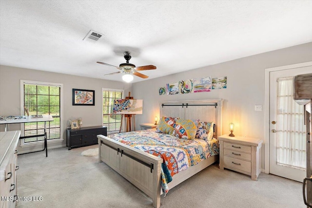 bedroom featuring baseboards, visible vents, a ceiling fan, and light colored carpet