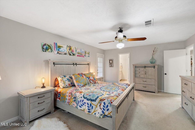 bedroom featuring visible vents, ceiling fan, light colored carpet, and baseboards