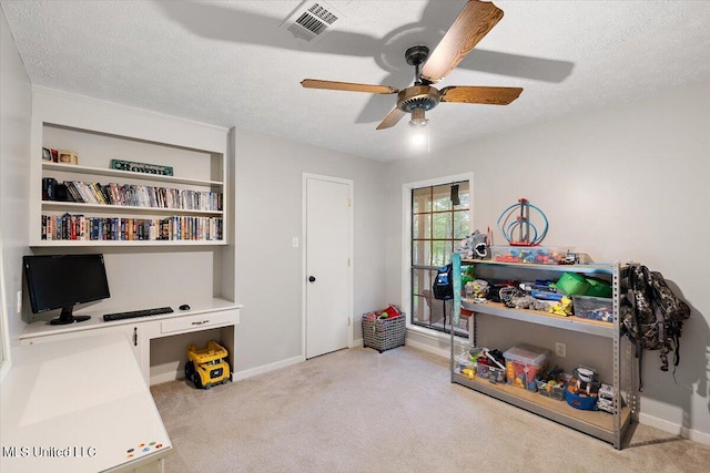 recreation room featuring carpet, ceiling fan, visible vents, and a textured ceiling