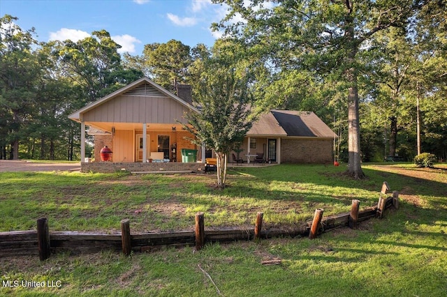 rear view of house featuring a lawn and a chimney