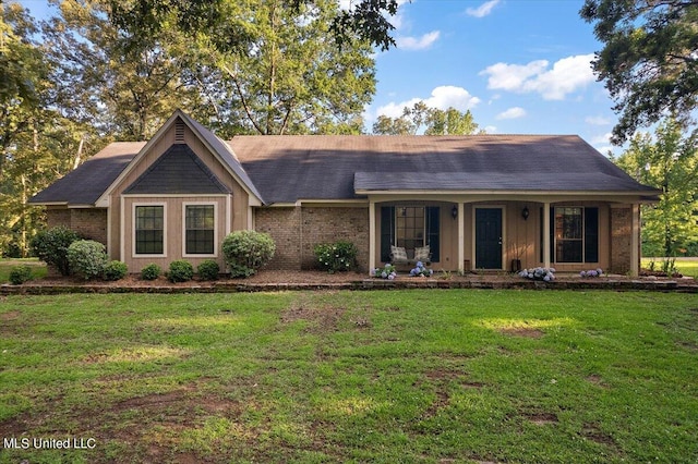 ranch-style house with covered porch and a front lawn