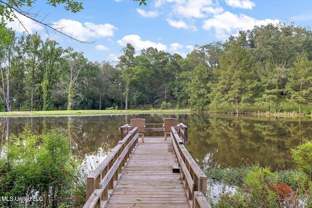 view of dock featuring a water view and a view of trees