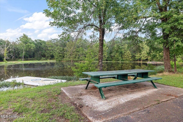 view of home's community featuring a water view and a forest view