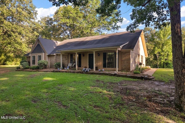 ranch-style home with a front lawn, covered porch, and brick siding