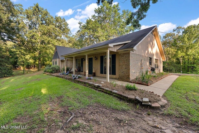 view of side of home featuring a lawn and brick siding