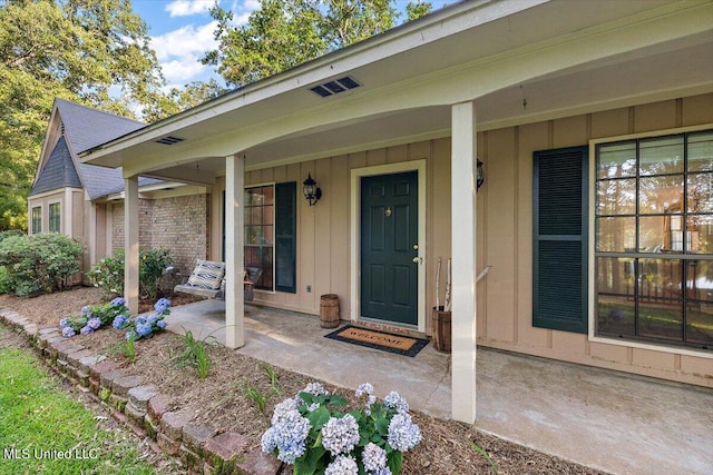 entrance to property featuring a porch and board and batten siding