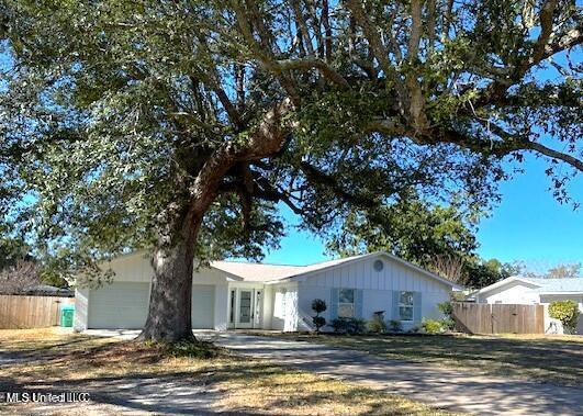7 Villa Cove Dr, Gulfport, MS 39507 - ranch-style house featuring an attached garage, fence, and driveway