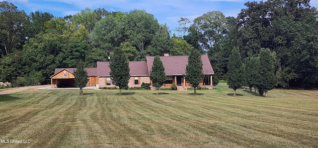 view of front of house with a front yard and a garage