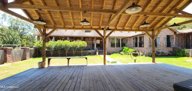 deck with a yard and ceiling fan