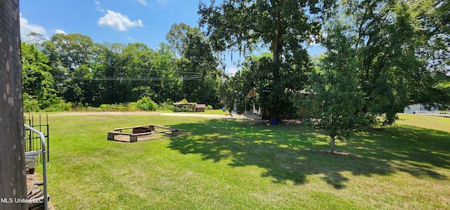 view of yard with a fire pit