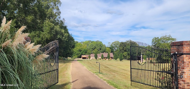 view of gate with a yard