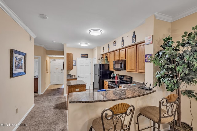 kitchen with kitchen peninsula, carpet, dark stone counters, ornamental molding, and black appliances