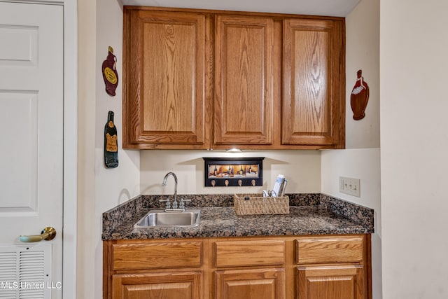 kitchen with sink and dark stone countertops