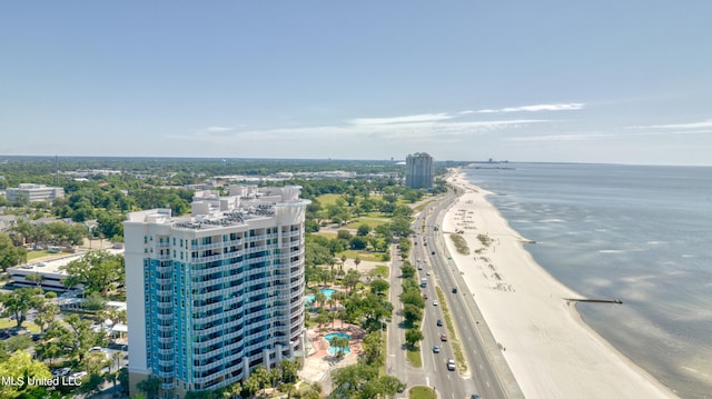 birds eye view of property with a water view and a beach view