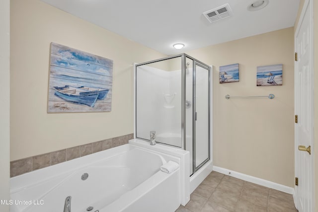 bathroom with tile patterned floors, baseboards, a shower stall, visible vents, and a bath