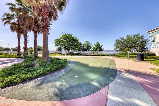 view of home's community featuring a water view and fence