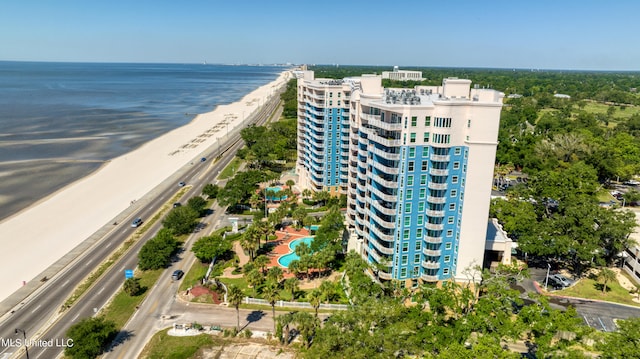 birds eye view of property with a water view and a beach view