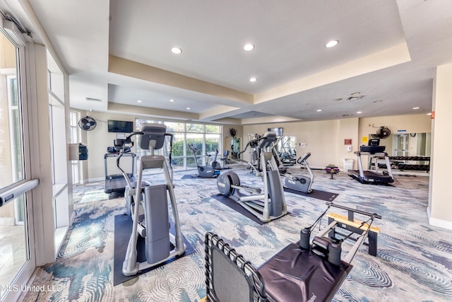 exercise room with carpet floors, recessed lighting, a raised ceiling, and baseboards