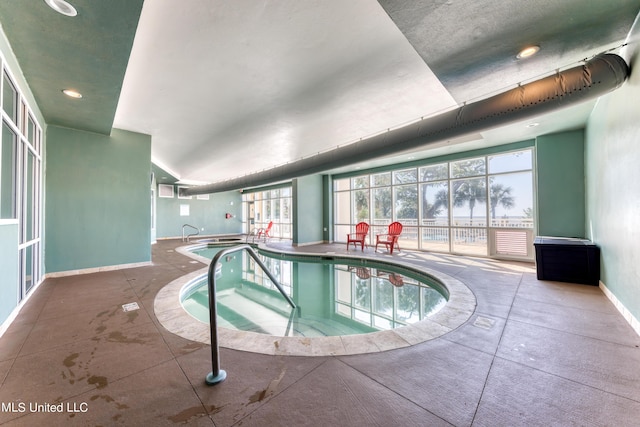 pool with an indoor in ground hot tub