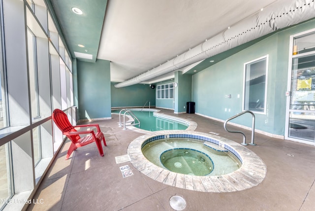 community pool featuring an indoor in ground hot tub