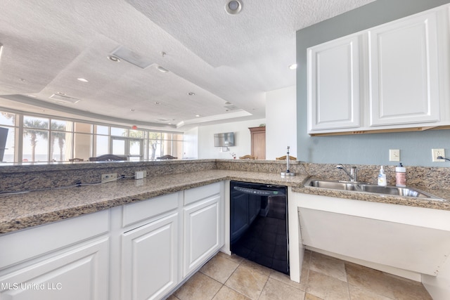 kitchen featuring white cabinets, black dishwasher, a textured ceiling, stone countertops, and sink