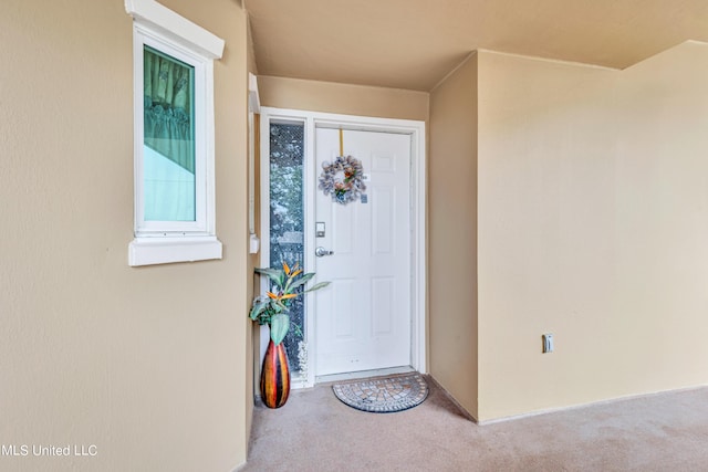 doorway to property featuring stucco siding