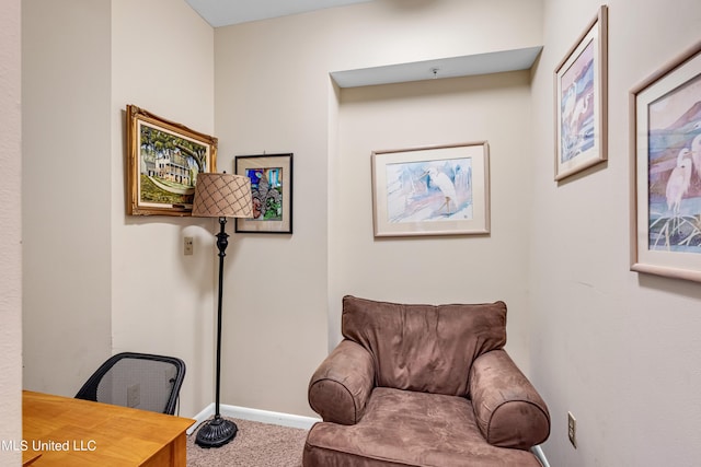 living area featuring carpet floors and baseboards