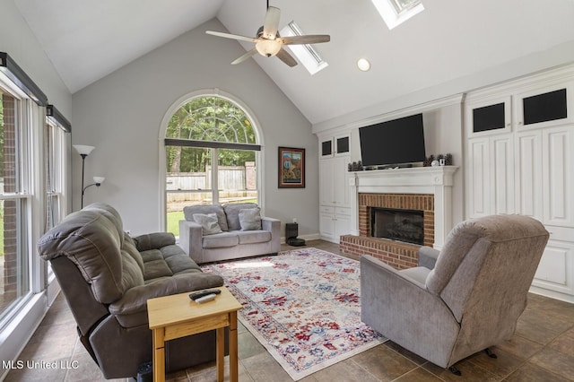 410 Woodland Hills Ct, Madison, MS 39110 - living area with high vaulted ceiling, ceiling fan, a fireplace, and a skylight