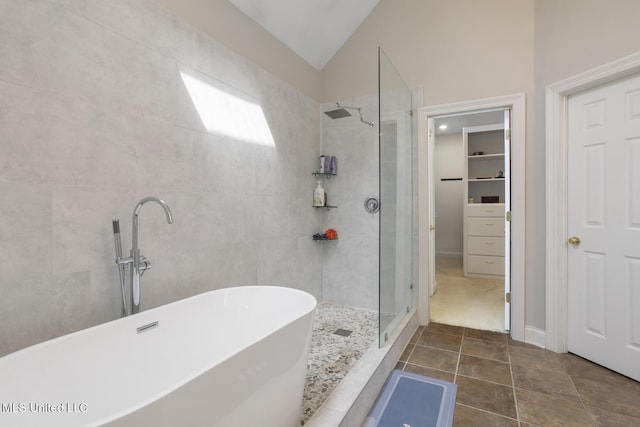 410 Woodland Hills Ct, Madison, MS 39110 - bathroom featuring a stall shower, lofted ceiling, a freestanding bath, tile patterned floors, and a spacious closet