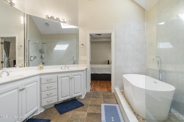 410 Woodland Hills Ct, Madison, MS 39110 - ensuite bathroom with lofted ceiling, a freestanding bath, double vanity, a skylight, and a shower