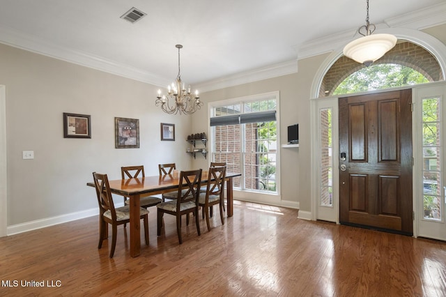 410 Woodland Hills Ct, Madison, MS 39110 - dining space featuring a chandelier, wood finished floors, and crown molding