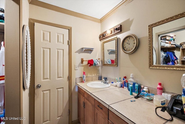 bathroom with ornamental molding and vanity