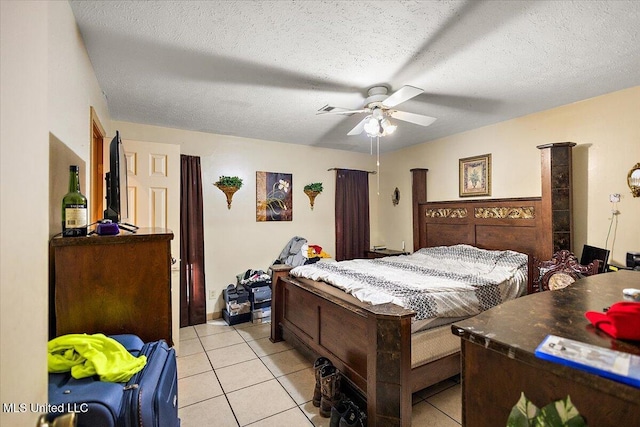 tiled bedroom with a textured ceiling and ceiling fan