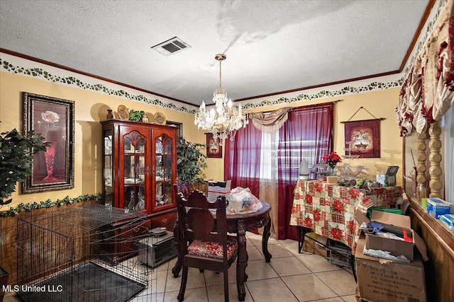 tiled dining area with a chandelier and a textured ceiling