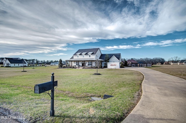 view of front of property with a porch, a front lawn, and concrete driveway