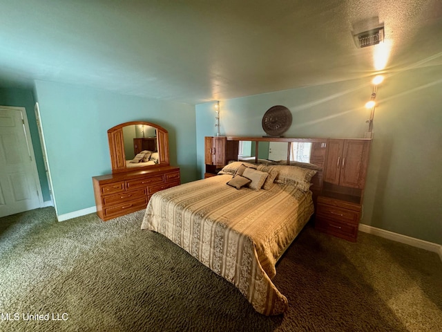 bedroom with dark colored carpet