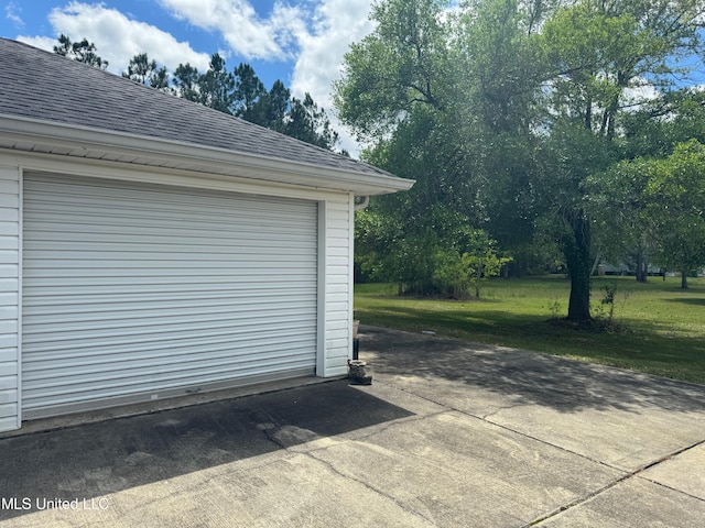 garage featuring a lawn