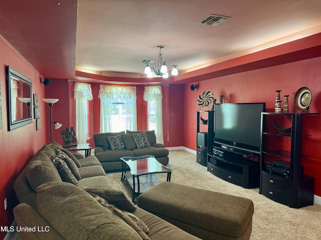 living room with carpet flooring, a chandelier, and a raised ceiling