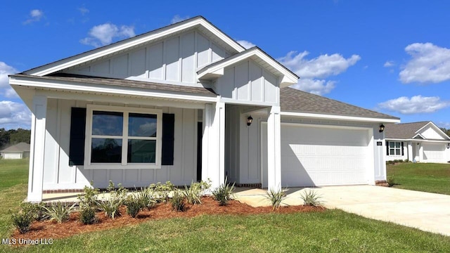 166 Mill Ct, Lucedale, MS 39452 - view of front of property with board and batten siding, a garage, a shingled roof, driveway, and a front lawn
